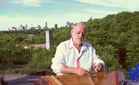 Vladimir Gorodkin - Music & Promo Video (2:03) showing Vladimir playing folk instrument called Tsimbaly with green trees and silhouette of Toronto